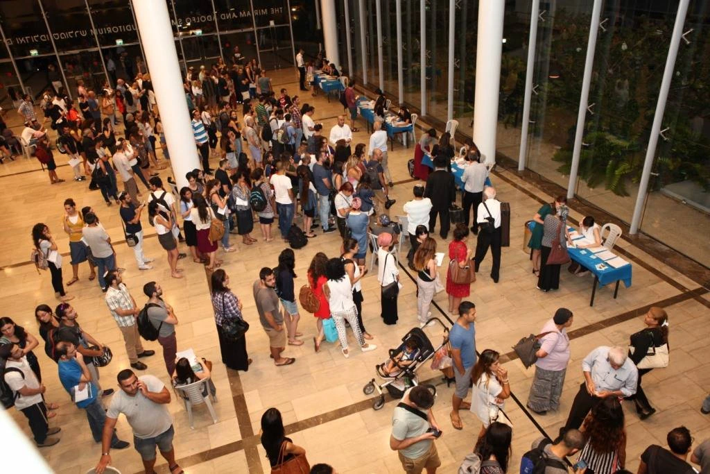 People in line at the registration desks at the Maccabim Foundation scholarship award ceremony